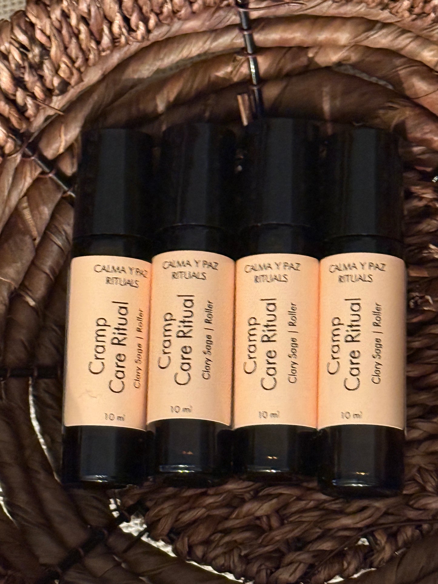Calma y paz rituals Roll-on bottles with beige labels on a woven surface