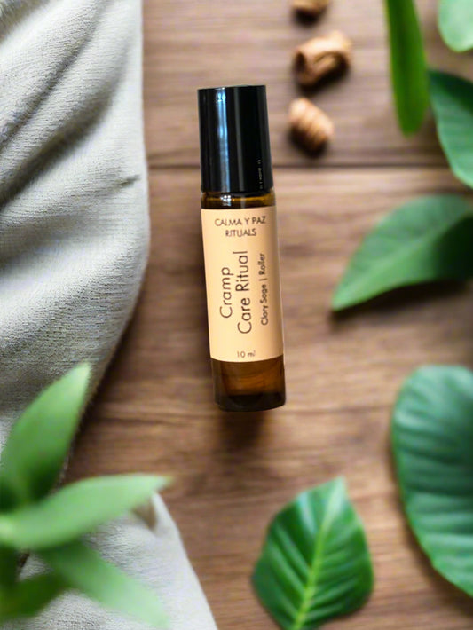 Calma y Paz rituals Roll-on bottle of cream on a wooden surface with a blurred background