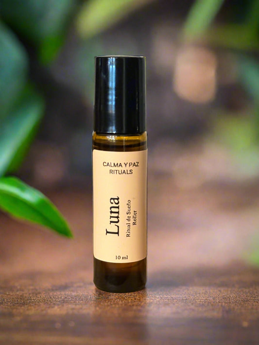 Calma y paz rituals Roll-on bottle labeled 'Luna' on a wooden surface with a blurred background