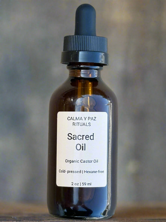 Bottle of 'Sacred Oil' with a dropper on a light gray background