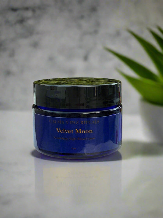 Blue jar with black lid labeled 'Velvet Moon' on a light gray background
